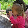 A young learner studies a bug