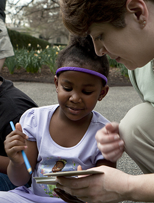 Girl journaling with instructor