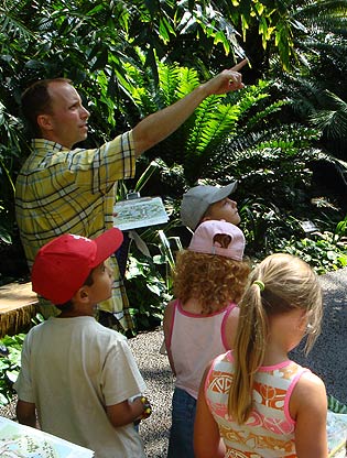 Teacher leading campers through Climatron