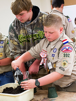 Boy scouts potting plants