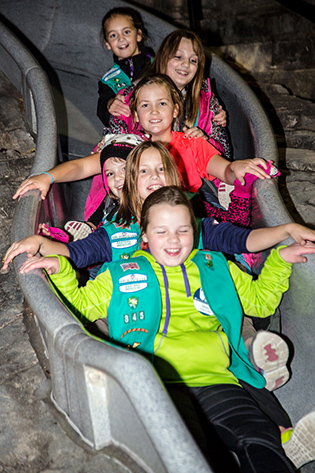 Girl scouts on slide in Childrens Garden