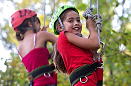 Girls suspended in tree