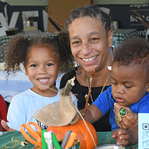 Mother and children with pumpkin crafts