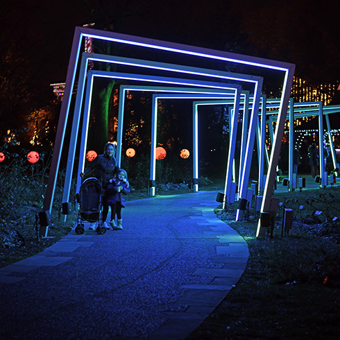 Illuminated geometric shapes along lit pathway