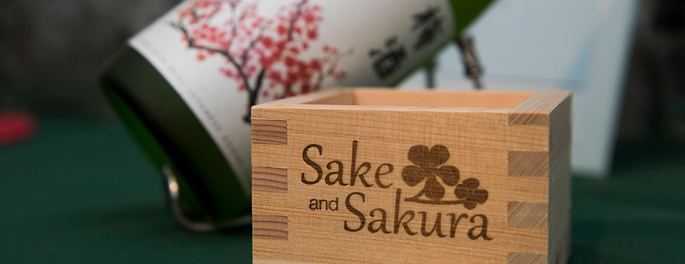 Sake cup with sake bottle in background