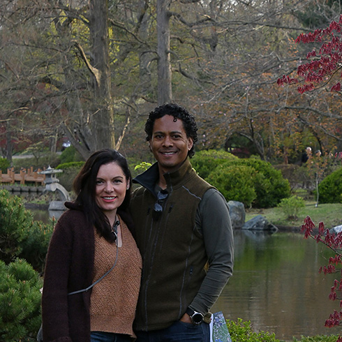 Couple posing in front of Japanese Garden lake