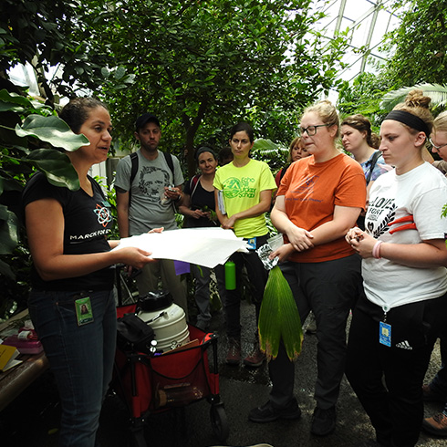 Group standing inside Climatron conservatory surrounded by tropical plants