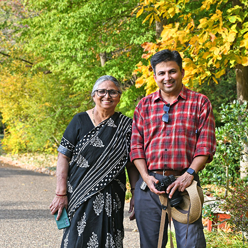 Woman and man in garden setting with fall foliage