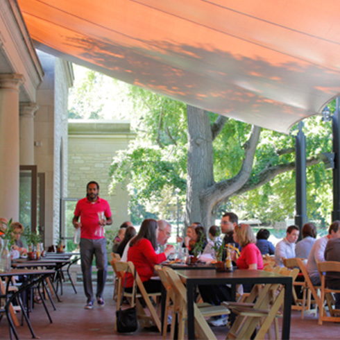 diners enjoy lunch under a canopy