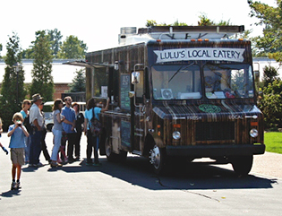 Festival-goers line up at Lulu's food truck