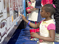 Girl painting bus