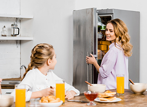 Mother and daughter with refrigerator