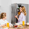 Mother and daughter with refrigerator
