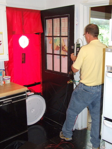 Man with blower door; photo by Korey Hart