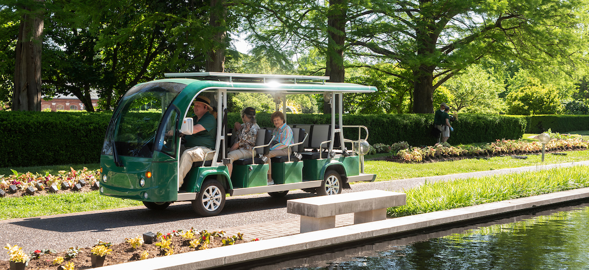Passengers enjoy a view of the Garden's Central Axis pools from aboard the Garden's eco-shuttle tram