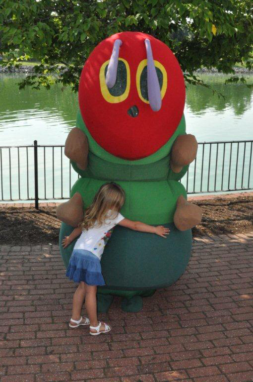 Young girl hugging the Very Hungry Caterpillar 