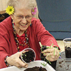 Senior potting up a plant