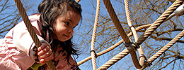 Girl climbing ropes in Children's Garden