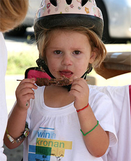 Child eating meat stick