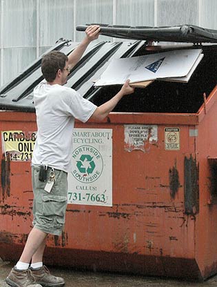 Employee recycling cardboard